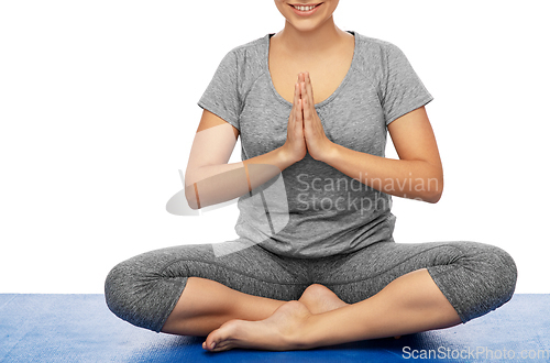 Image of woman doing yoga in lotus pose