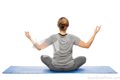 Image of woman doing yoga in lotus pose