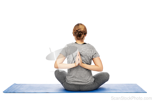 Image of woman doing reverse prayer pose on mat