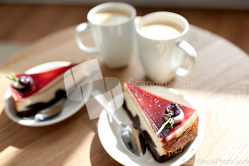 Image of pieces of chocolate cake on wooden table