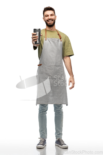 Image of happy waiter with tumbler or takeaway thermo cup