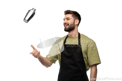 Image of happy barman with shaker preparing