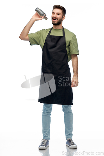 Image of happy barman in apron with shaker preparing drink