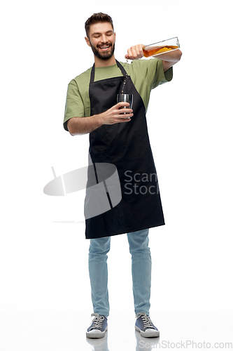 Image of barman with bottle and shaker preparing drink