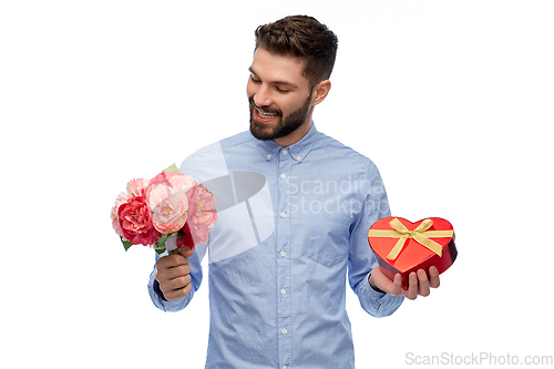 Image of happy man with flowers and valentine's day gift