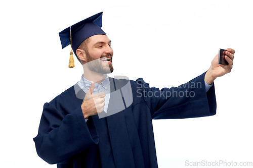 Image of male graduate student with smartphone takes selfie