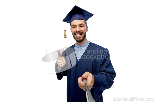 Image of male graduate student taking selfie with monopod