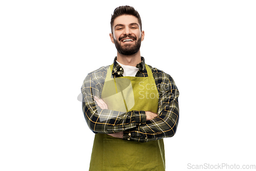 Image of happy young male gardener or farmer in apron