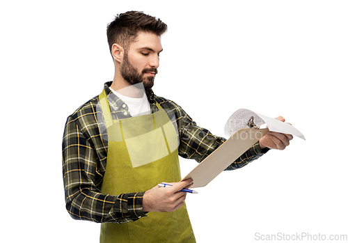 Image of male gardener with clipboard and papers