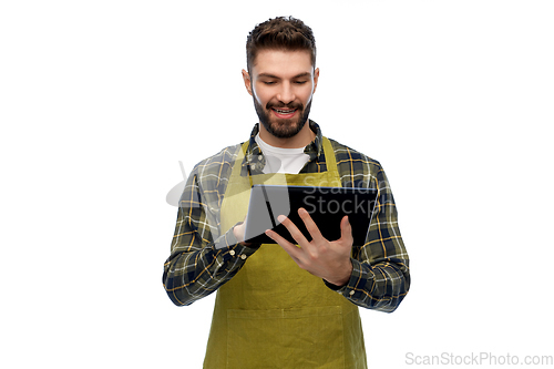 Image of happy male gardener or farmer with tablet pc