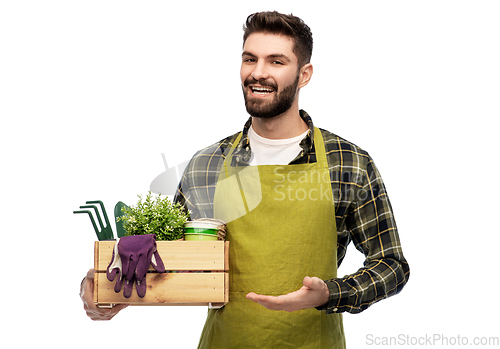 Image of happy gardener or farmer with box of garden tools