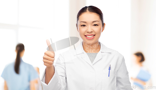 Image of asian female doctor showing thumbs up at hospital