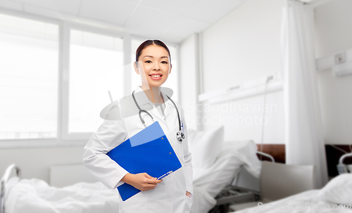 Image of asian female doctor with clipboard at hospital