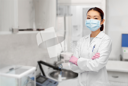 Image of asian female doctor or scientist in medical mask