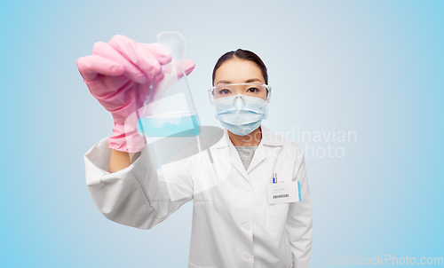 Image of asian doctor or scientist in mask with flask