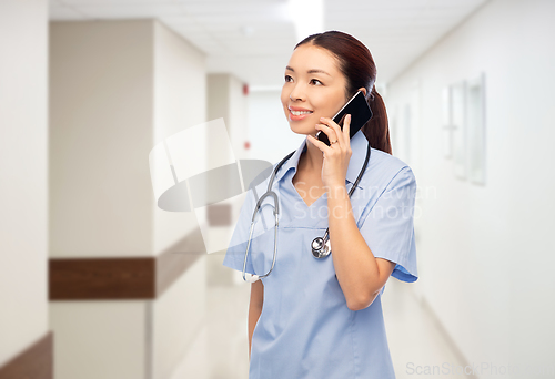 Image of asian nurse calling on smartphone at hospital