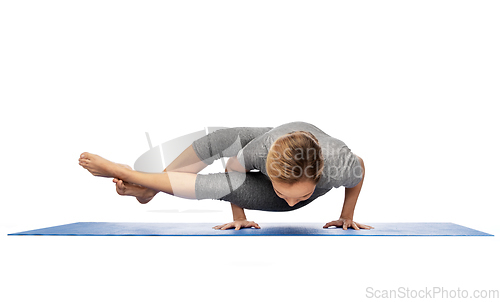 Image of woman making yoga in handstand on mat