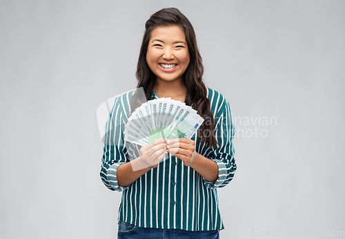 Image of asian woman with hundred euro money banknotes