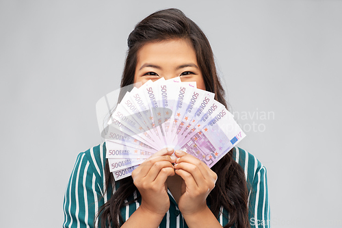 Image of asian woman with hundred euro money banknotes