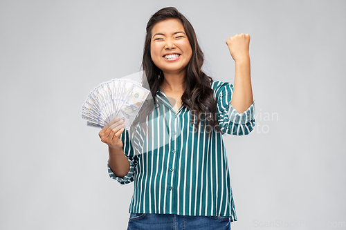 Image of happy asian woman with money celebrating success