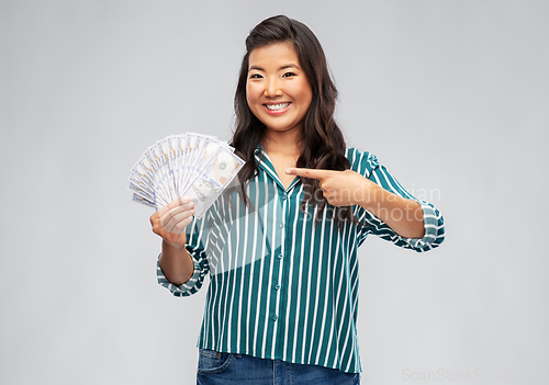 Image of asian woman with hundred dollar money banknotes