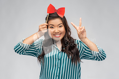 Image of happy asian woman with red party bow