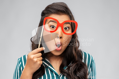 Image of happy asian woman with big party glasses