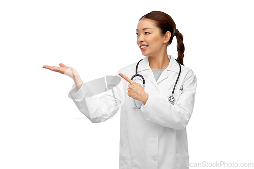 Image of asian female doctor holding something on hand