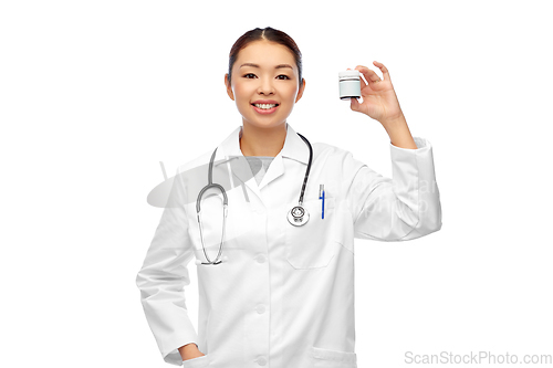 Image of smiling asian female doctor or nurse with medicine