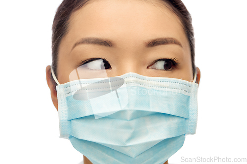 Image of close up of asian woman in protective medical mask