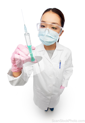 Image of asian doctor in mask with medicine in syringe