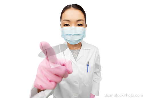 Image of asian female doctor in mask pointing finger to you