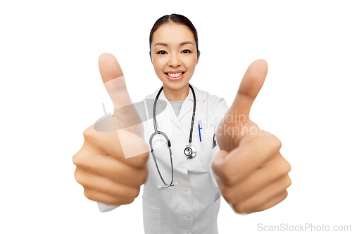 Image of smiling asian female doctor showing thumbs up