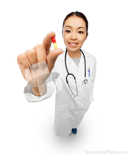 Image of asian doctor with medicine and glass of water