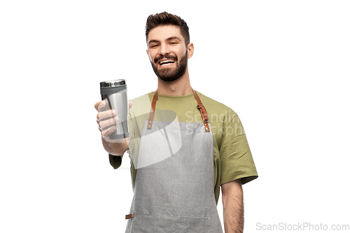 Image of happy waiter with tumbler or takeaway thermo cup