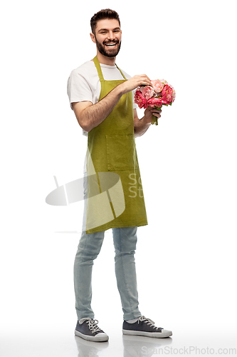 Image of smiling male gardener with bunch of peony flowers