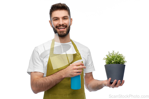 Image of happy smiling male gardener moisturizing flower