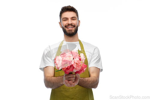 Image of smiling male gardener with bunch of peony flowers