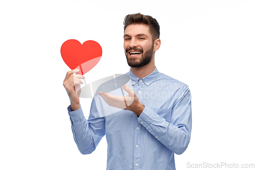 Image of happy smiling young man with red heart