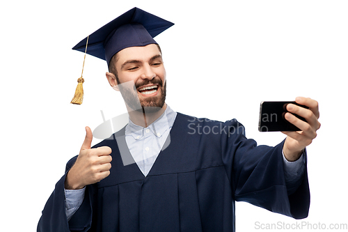 Image of male graduate student with smartphone takes selfie