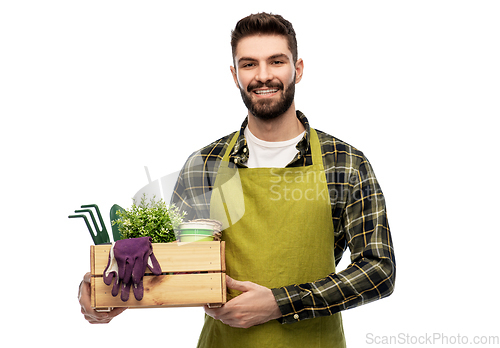 Image of happy gardener or farmer with box of garden tools