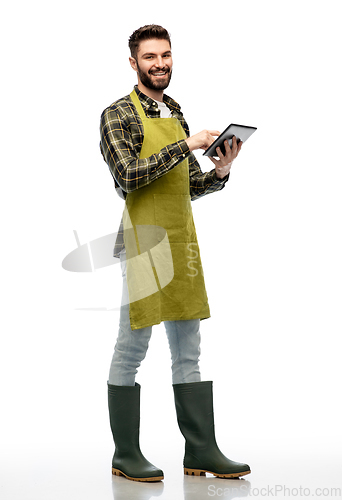 Image of happy male gardener or farmer with tablet pc