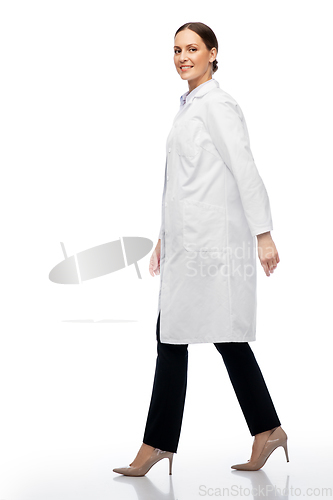 Image of smiling female doctor or scientist walking