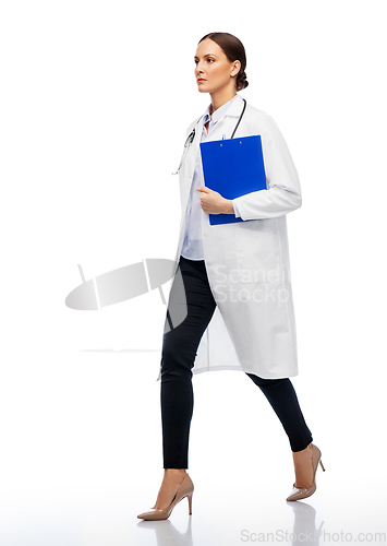 Image of female doctor walking with clipboard