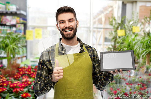 Image of flower seller with tablet pc shows thumbs up