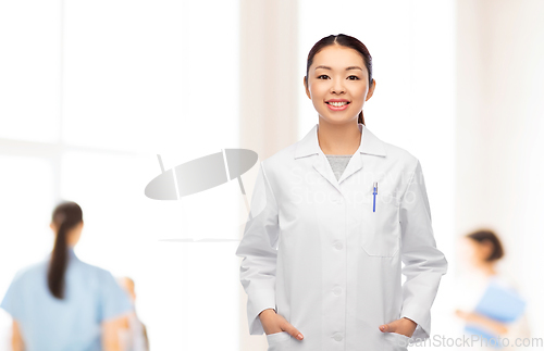 Image of happy smiling asian female doctor at hospital