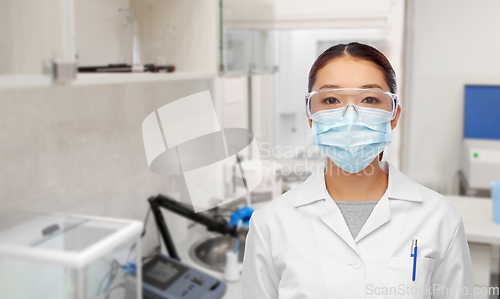 Image of asian female doctor or scientist in medical mask