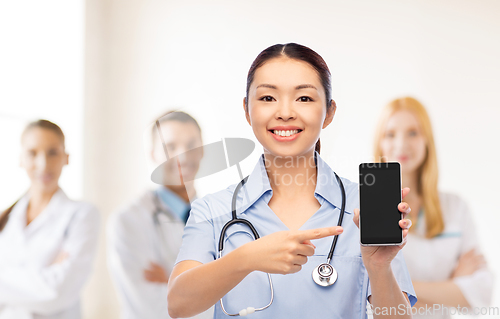 Image of happy asian female doctor or nurse with smartphone