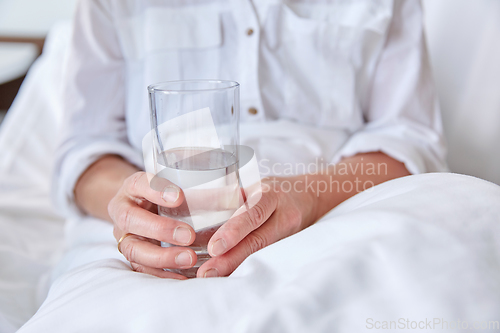 Image of close up of senior woman with water at hospital