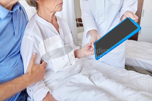 Image of senior woman and doctor with tablet pc at hospital